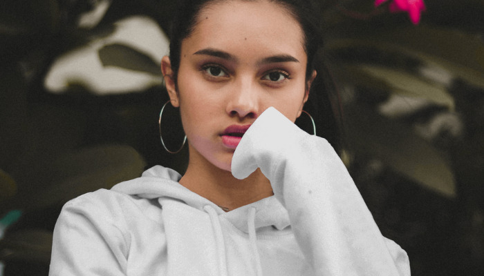 posing in garden with white hoodie