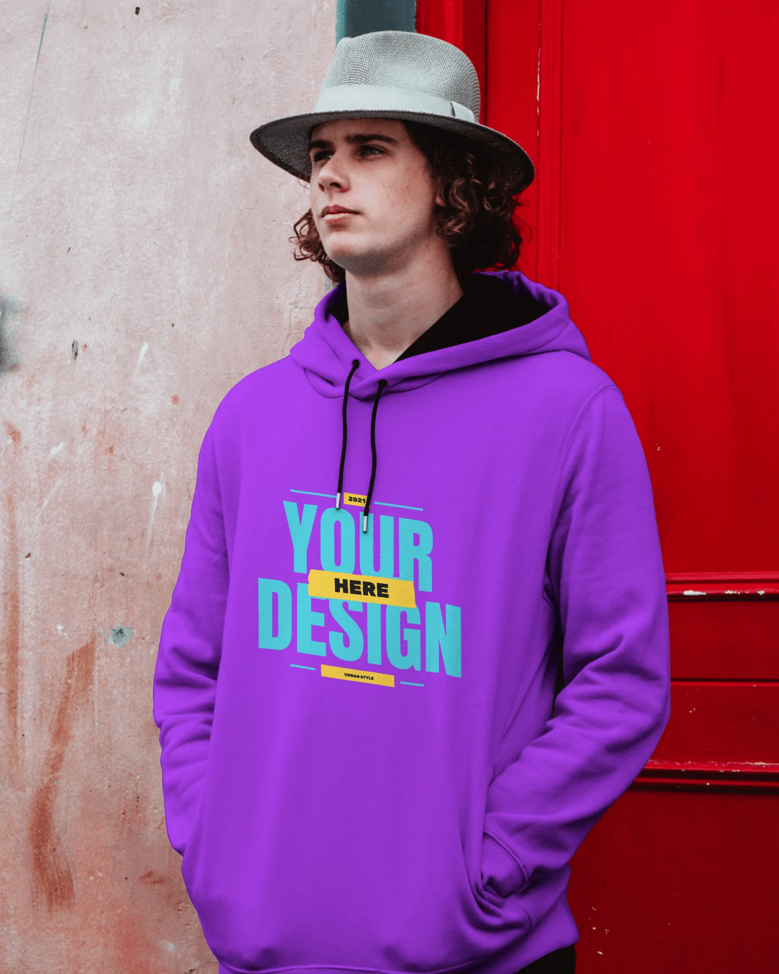 A man wearing a purple hoodie Mockup and standing outside the door