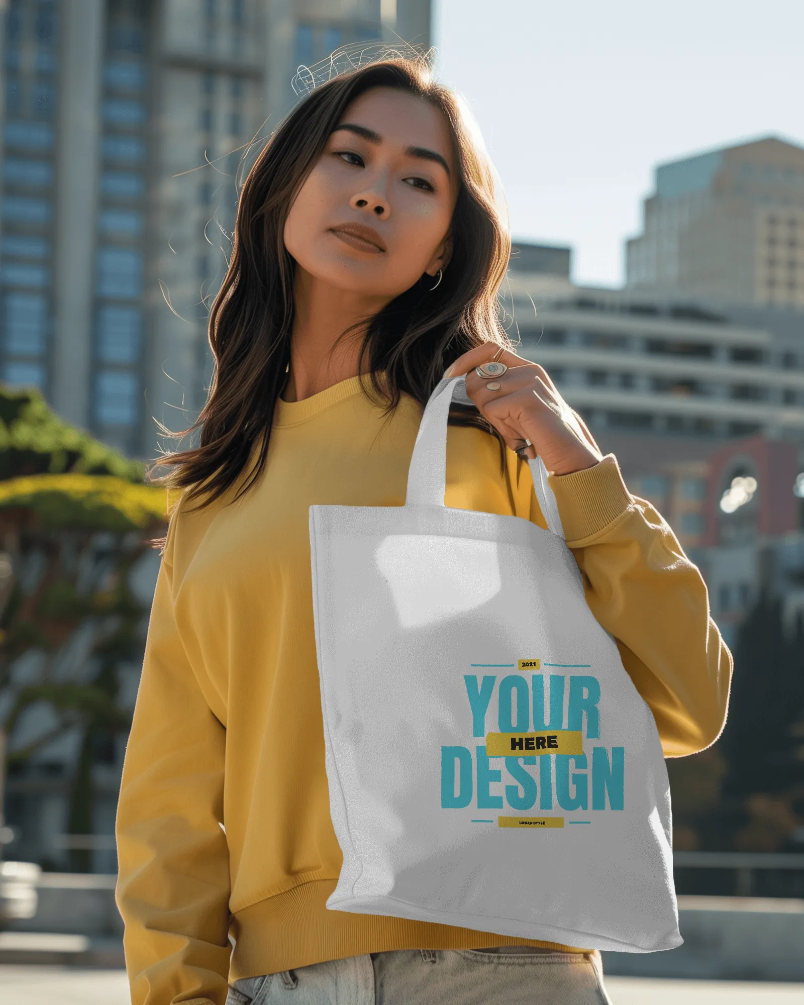 asian woman holding tote bag mockup in right hand