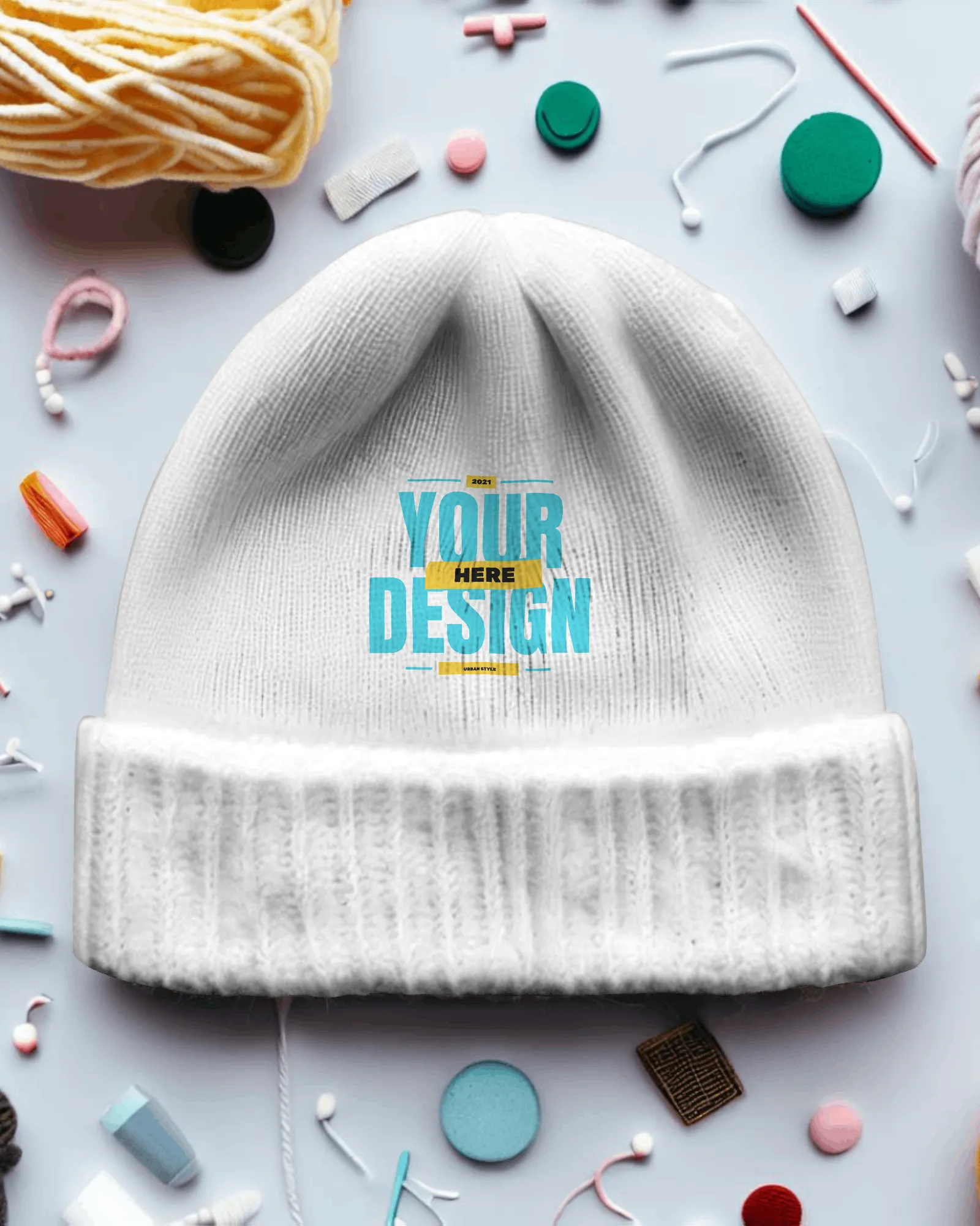 beanie-mockup-on-table-flatlay-with-stitching-materials-in-background