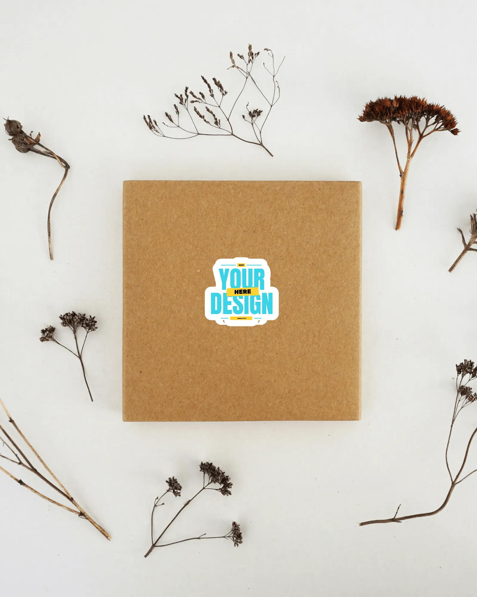 sticker mockup on a corrugated box with leaves in background