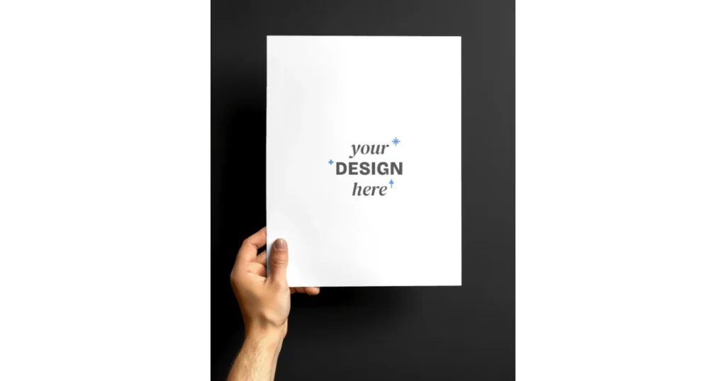 The mockup of the paper poster in hand is surrounded by a dark environment