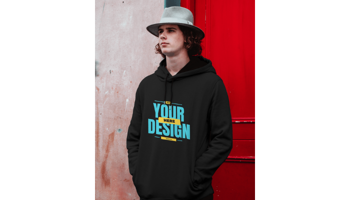 a boy in black hoodie template in front of a red door