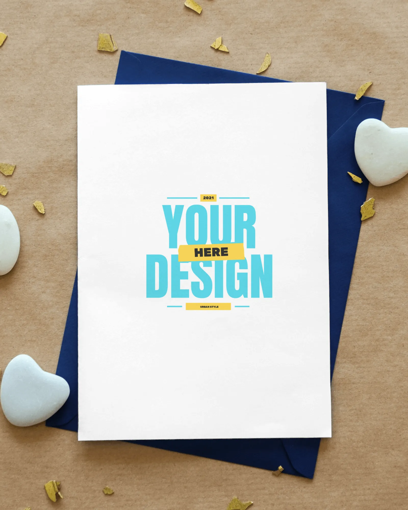 greeting card mockup on sand paper with heart shaped stones lying beside 