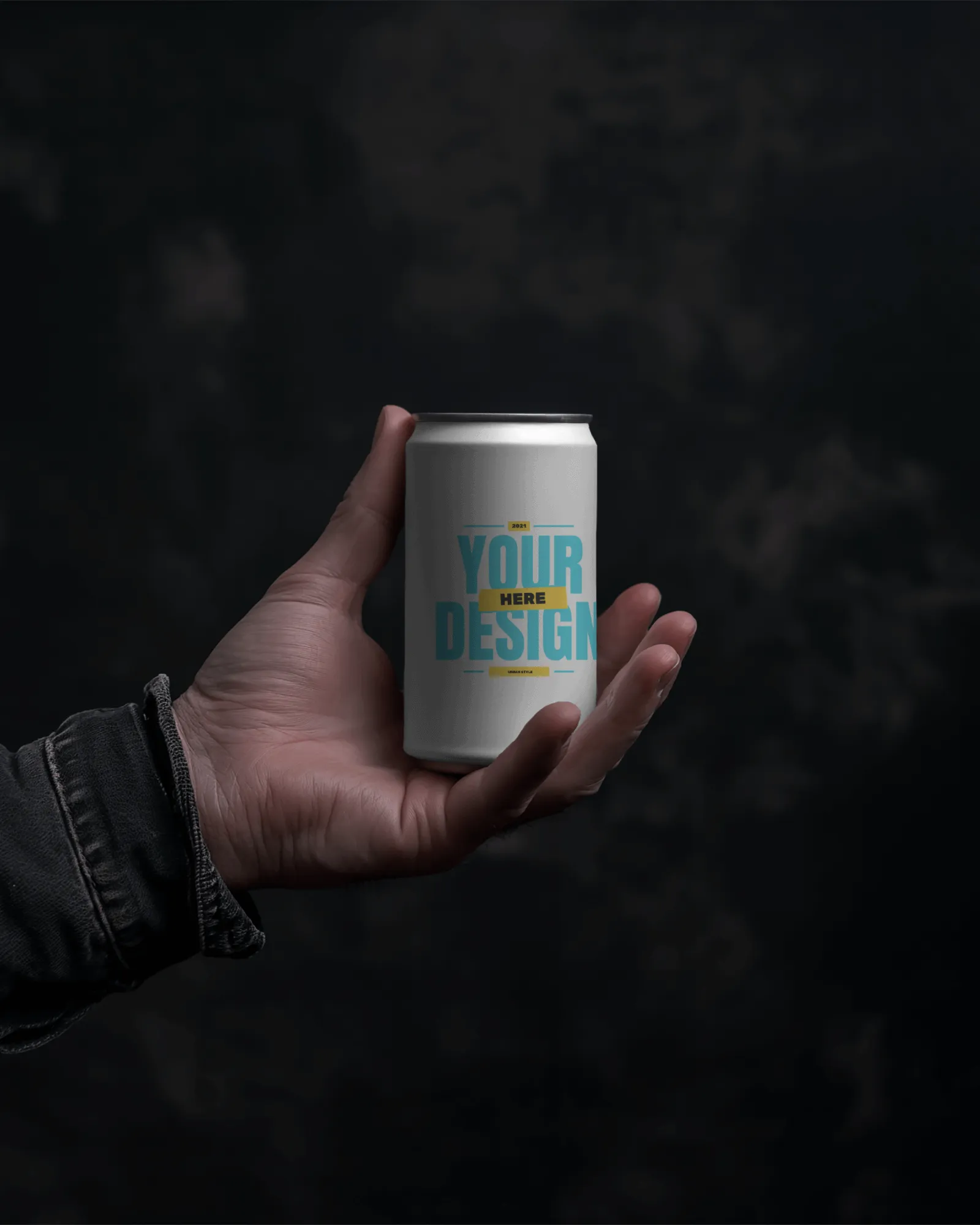 hand holding can mockup in front of dark screen