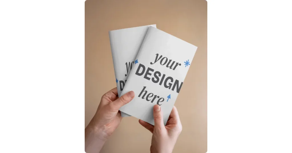 someone holding two a4 brochures