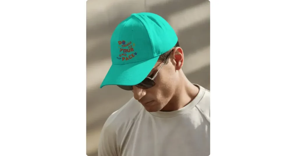 a model looking down wearing a baseball cap
