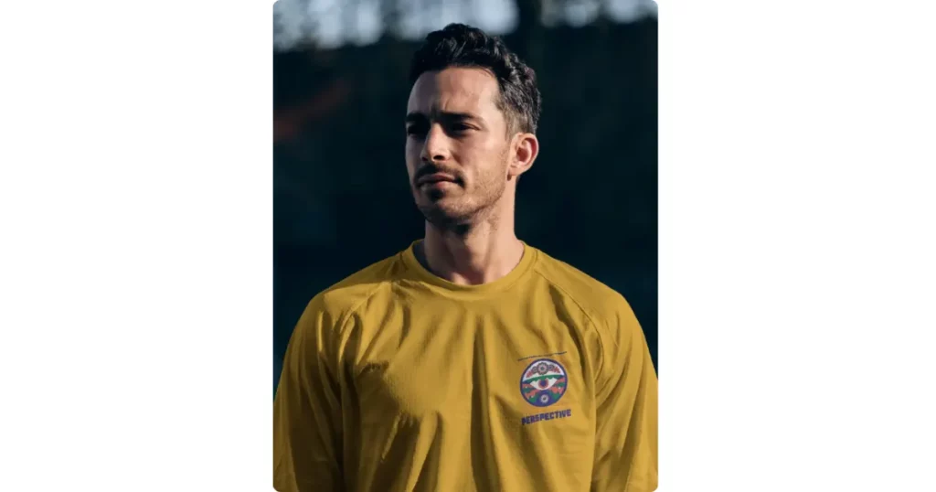 a player in a football jersey standing against a dark backdrop