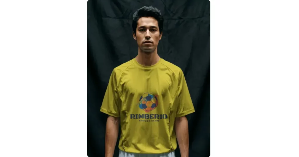 a player stands wearing a football jersey against a black cloth
