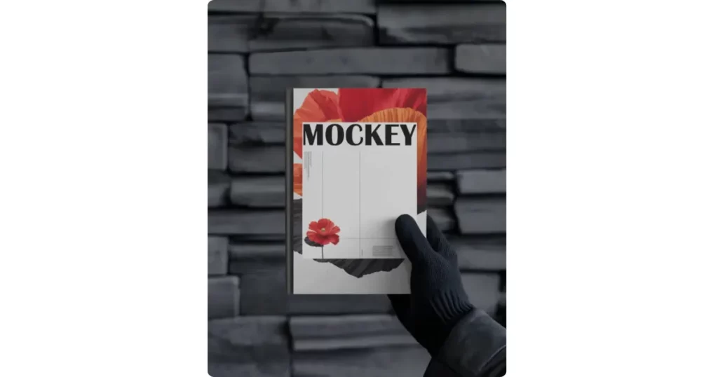an a4 book held by a gloved hand