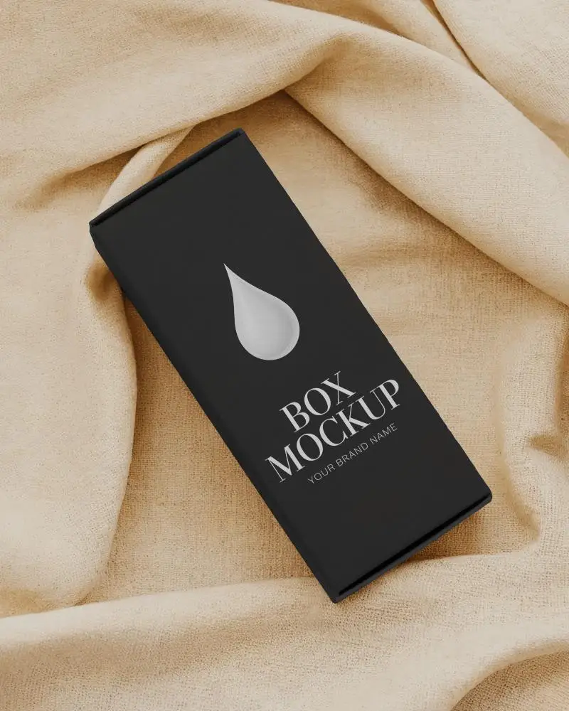 rectangular box mockup resting on wrinkled beige cloth top angle soft light