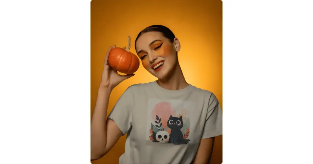 a model smiling and holding a small pumpkin