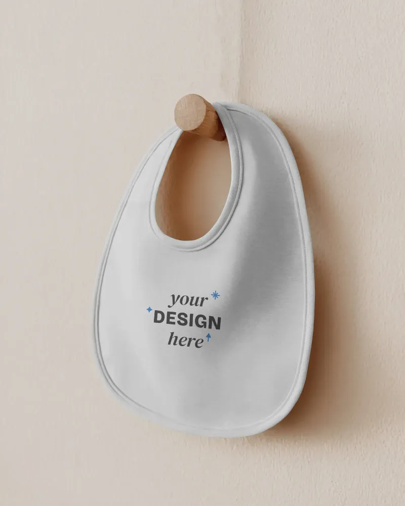 blank baby bib hanging on wooden