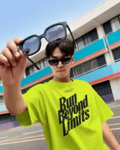 street style tshirt mockup male model holding sunglasses outdoor urban court setting